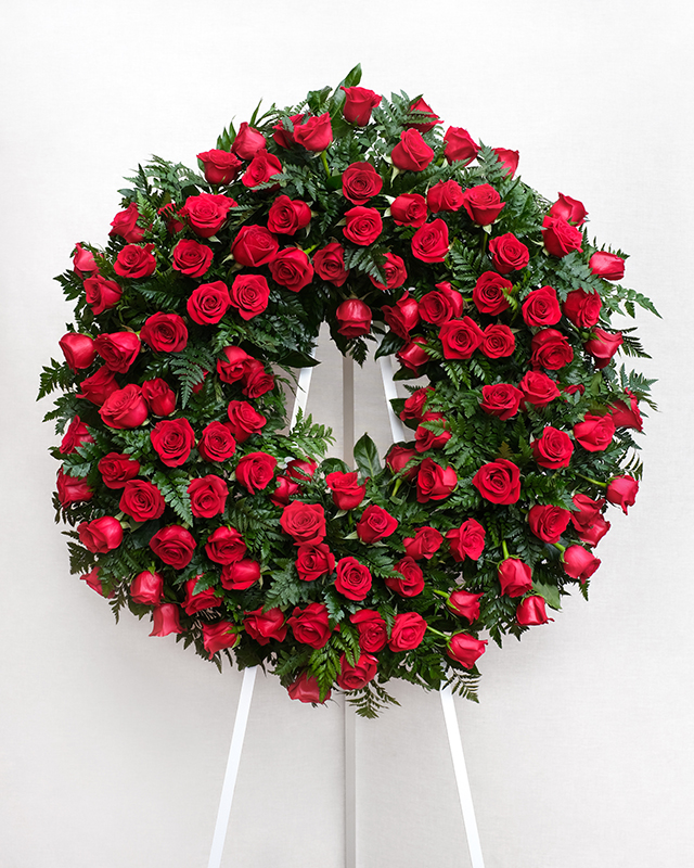 Corona de 100 roses vermelles, amb leder i aspidistra